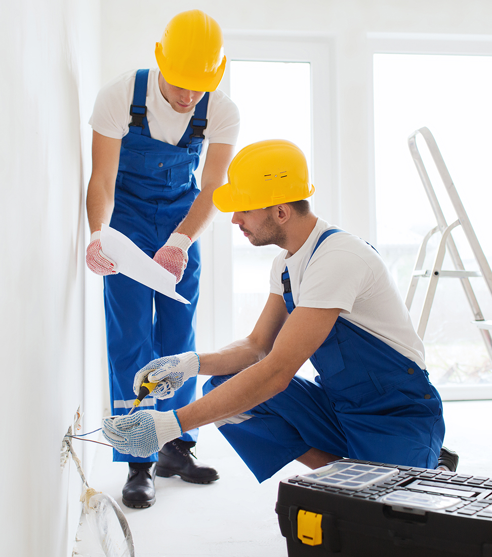 builders with tablet pc and equipment indoors